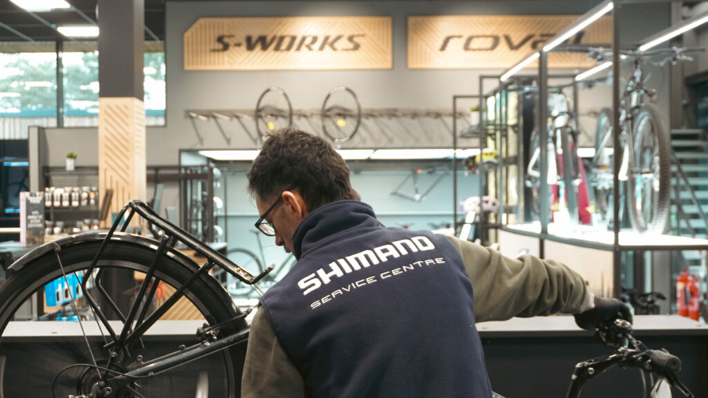 A man completing a service on a bike.